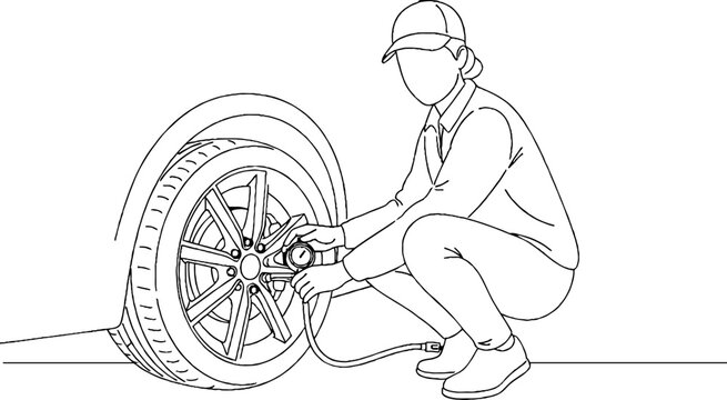 Person changing a flat tire on a car.