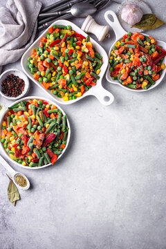 Frozen mix of vegetables on dark background