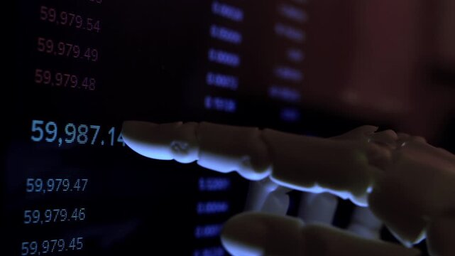 Cinematic close up of humanoid robot hand analyzing economic data from computer monitor. AI business metaphor, numbers on screen, dark office, shallow depth of field, natural dim light.