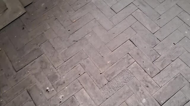 Worn herringbone wooden floor texture moving in slow motion video footage