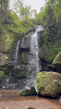 Landscape of a beautiful waterfall in a tropical forest setting.