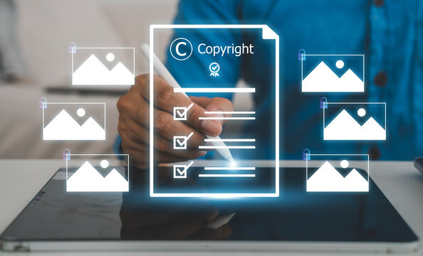 Businessman with virtual copyright icon and photo hologram, Intellectual property protection, digital asset licensing, stock photo video rights and creative content legal ownership system