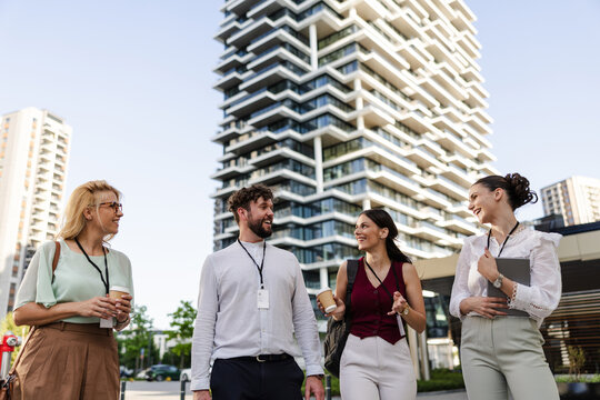 Group of diverse professionals walking together in urban setting