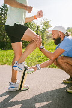 A running coach assists a client during a training session