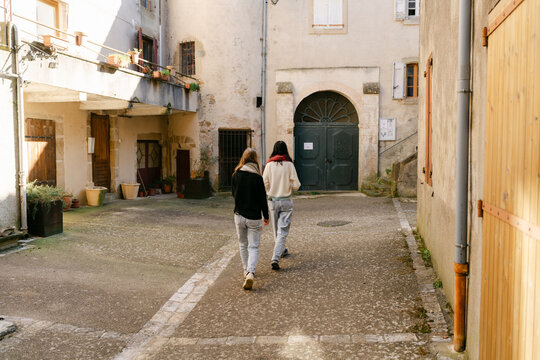 two young women walking in village in the South of France
