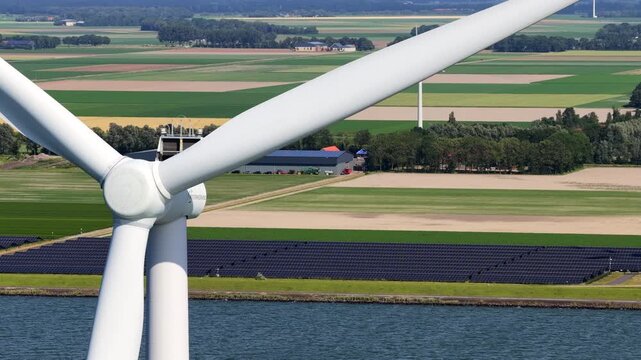 Aerial view of wind turbines and solar panels along the IJsselmeer in the Netherlands