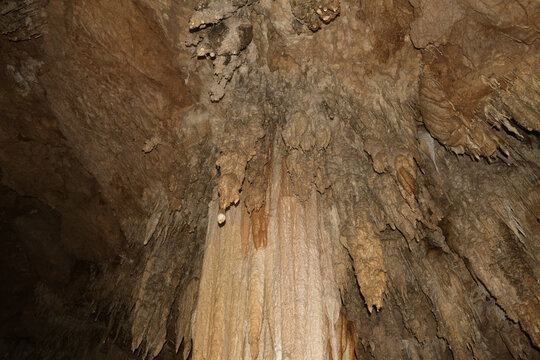 towering flowstone and intricate limestone formations rise toward the cave ceiling inside khao wang thong cave, revealing thousands of years of mineral deposition in southern thailand