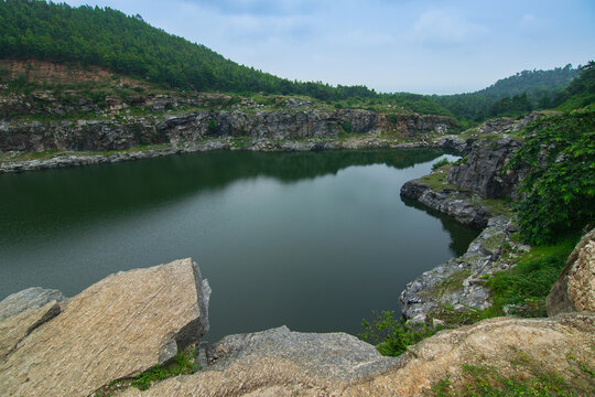 Top view of Tarpania Lake, Marble Lake, Blue Dam, Patal Dam or Durga Bera,a scenic lake in the Ajodhya Hills of Purulia, West Bengal, India. Water surrounded by sharp, white, marble-like rocky cliffs.