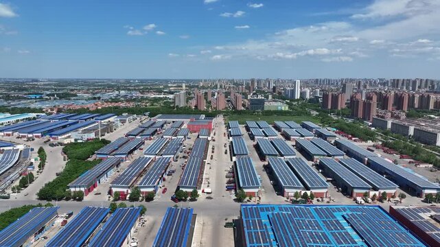 Aerial view of large logistics park with solar panel arrays on rooftops