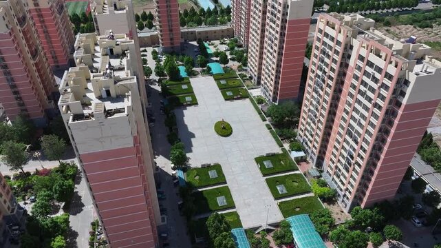Aerial view of a modern residential complex with landscaped courtyards and green spaces