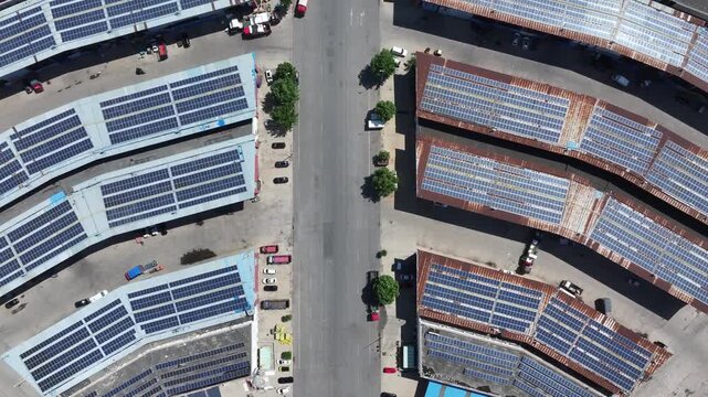 Aerial view of distributed photovoltaic power generation arrays installed on factory rooftops
