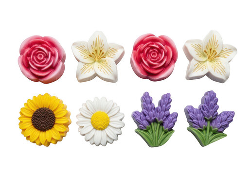 Collection of colorful floral shaped soaps or decorations including roses, sunflowers, daisies, and lavender, on black