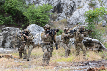 Fototapeta premium Military participate in a patrol in forrest terrain