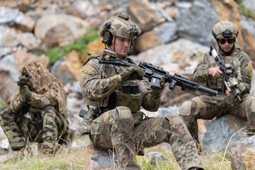 Fototapeta premium Soldier inspecting rifle during the mission