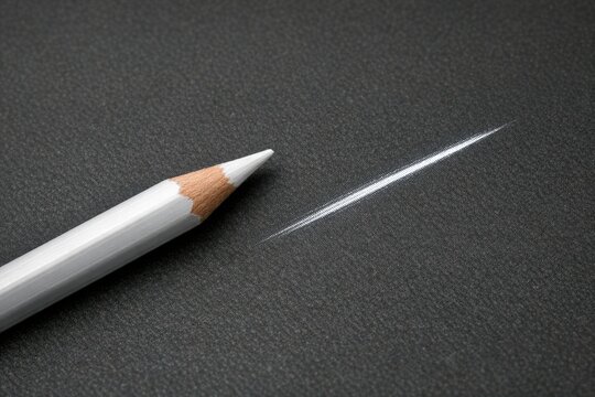 A white pencil with a pointed tip on a black background, ready for writing or drawing