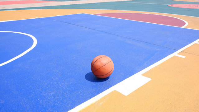 Basketball on outdoor sport court with colorful pattern on concrete floor surface, Sports field in minimal design background