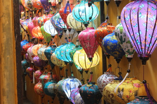 Rows of illuminated colorful handmade silk lanterns lining the historic city streets.