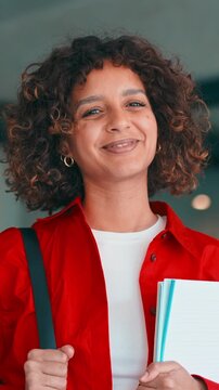 Female multicultural teenager student girl holding notebooks backpack indoors smiling at school or university campus. Young muslim or indian woman smiling at camera. Education and motivation. Vertical