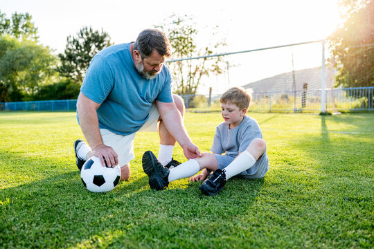 Boy having small accident during football training.