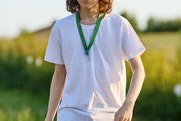 Fototapeta premium Person wearing sunflower lanyard for invisible disability awareness
