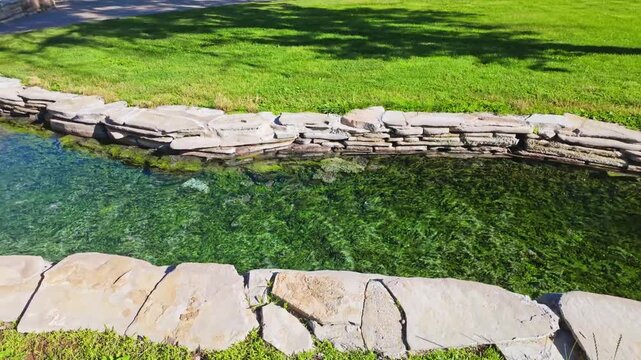 Natural thermal spring flowing through Hot Springs State Park in Thermopolis Wyoming with steaming mineral water
