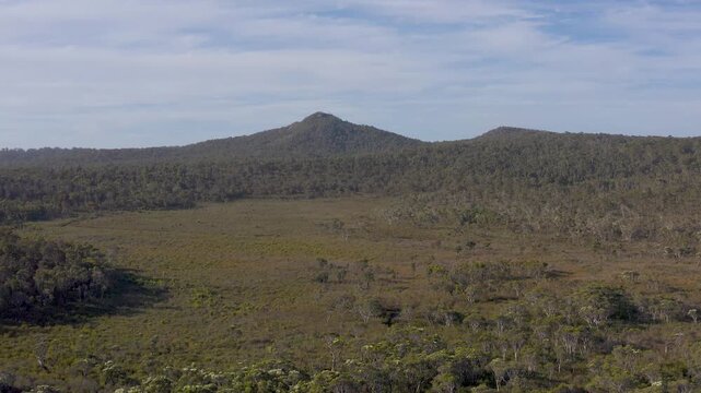 flat plain in front of the mountains in the bushland area, drone shot of the mountains, Video, Walpole, Western Australia