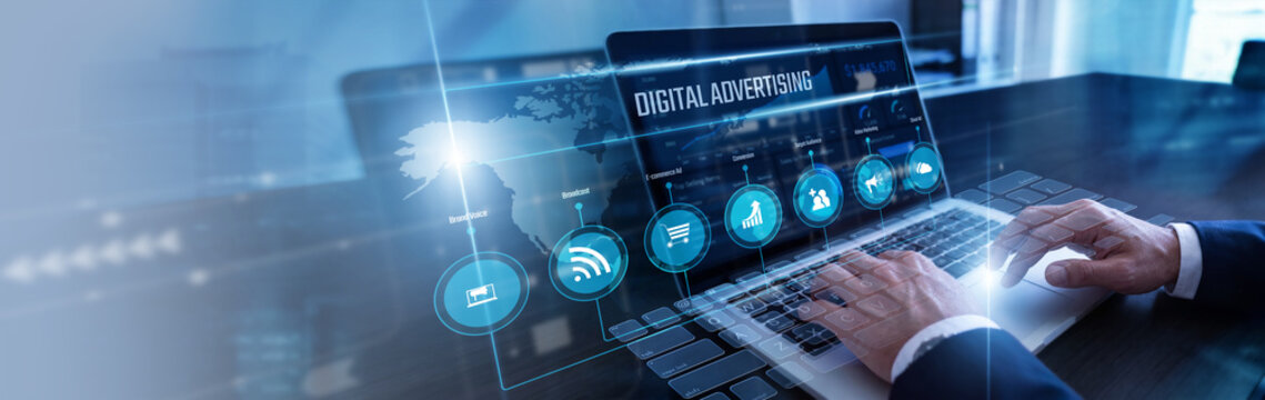 Media planner optimizing campaigns using laptop tracking global Digital Advertising ROI on a high-tech virtual screen projection. Strategic brand promotion and online target market reach.