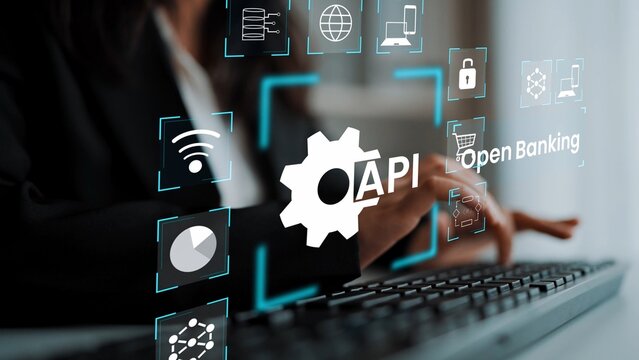 Professional and Modern Businesswoman Working on Keyboard Surrounded by Digital Icons Representing API and Open Banking Concepts in a Tech Environment Gluon.