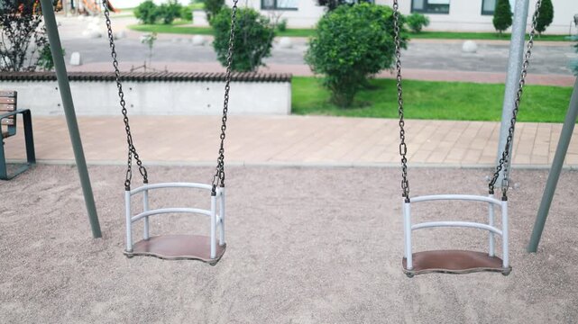 Playground in the park with hammocks swinging alone. Outdoor games for children. Hammocks, slides and colorful climbers. Nobody.