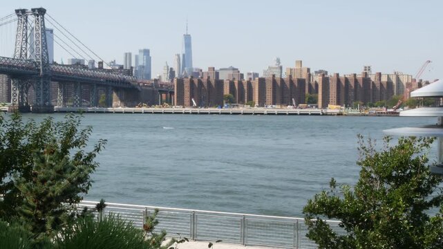 Williamsburg Bridge in Brooklyn, New York City, United States. Transport metallic bridge near Marcy Av subway station and Domino park in Williamsburg. World Trade Center skyscraper tower on Manhattan.