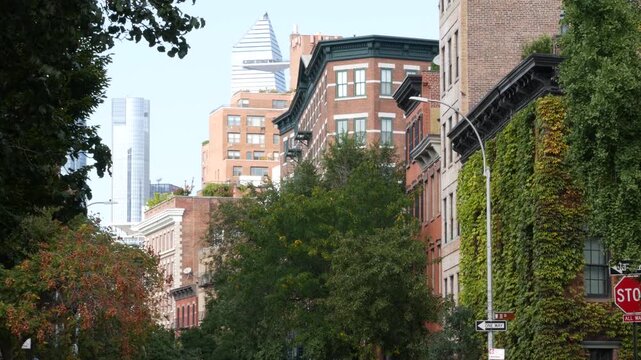 New York City urban residential buildings architecture, Lower Manhattan West village Greenwich street corner, United States of America. Greenwich village, USA. Red brick house. Vine greenery on wall.