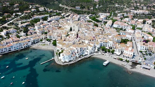 Aerial view of the picturesque fishing village of Cadaqu&eacute;s, featuring its whitewashed houses, historic waterfront, peaceful harbor and the crystal-clear waters of the Mediterranean on the Costa Brava.
