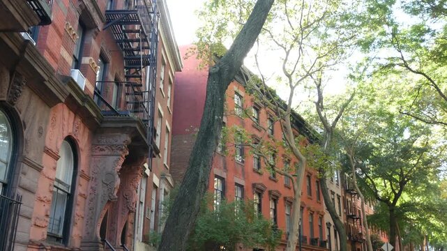 New York City urban residential buildings architecture, Manhattan classic street, Greenwich village, United States of America. Typical red brick house in NYC, real estate property in USA. West village