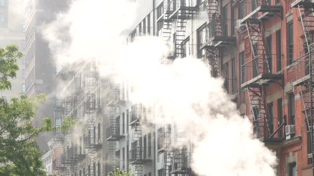 New York City urban residential buildings architecture, Manhattan classic street, United States of America. Typical red brick house, real estate property, USA. Fire escape metallic ladder. Hot steam.