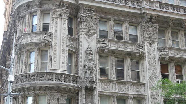 New York City Manhattan Midtown historic building 1909, facade architecture, United States of America. Real estate property on 7 seventh avenue. Classic style design landmark. Windows and greenery.