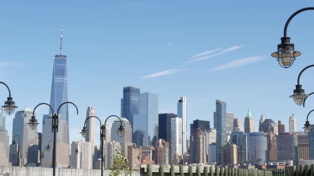 New York City Manhattan Downtown Financial District skyline, World Trade Center tower from New Jersey Liberty state park, United States. Pier lantern lamps and urban cityscape, skyscraper buildings.