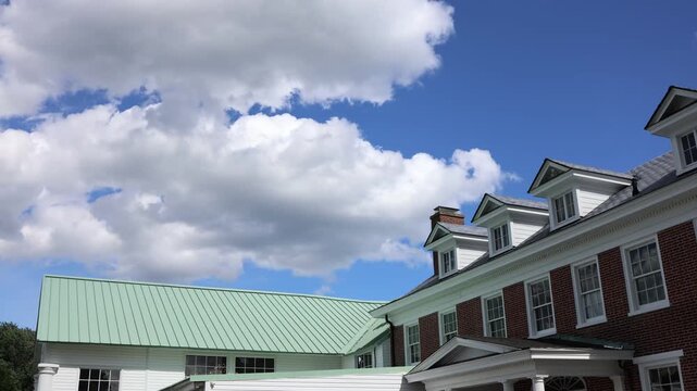 Red brick building under blue sky with clouds