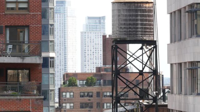 New York City Midtown East urban residential buildings, red brown brick architecture, Manhattan rooftop, United States of America. Water towers on roof. Cityscape with classic water tanks, Turtle Bay.