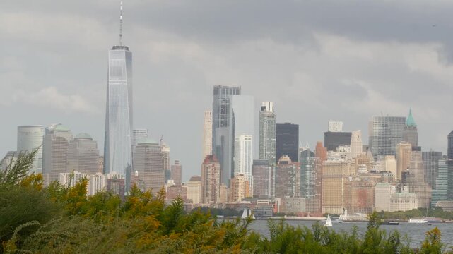 New York City Manhattan Downtown skyline from Liberty Island, United States. Financial District cityscape, World Trade Center skyscraper tower. Building architecture. Rainy cloudy autumn fall weather.