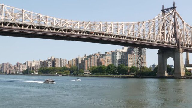 New York City Manhattan Midtown, Queensboro bridge architecture in United States. Urban transport bridge. Metallic bridge over East River, esplanade park in East Side. Roosevelt island. Road to Queens