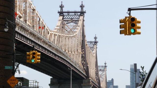 New York City Manhattan Midtown, Queensboro bridge architecture in United States. Urban transport bridge over East River. Yellow traffic light under metallic bridge in East Side. First 1st avenue.
