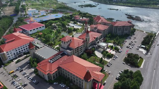 Aerial view of red-roofed architectural complex in Rizhao adjacent to water body