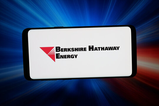 Stuttgart, Germany - 06-22-2026: In this photo illustration, the logo of US company Berkshire Hathaway Energy (BHE) is displayed on a smartphone in front of abstract background on computer screen.