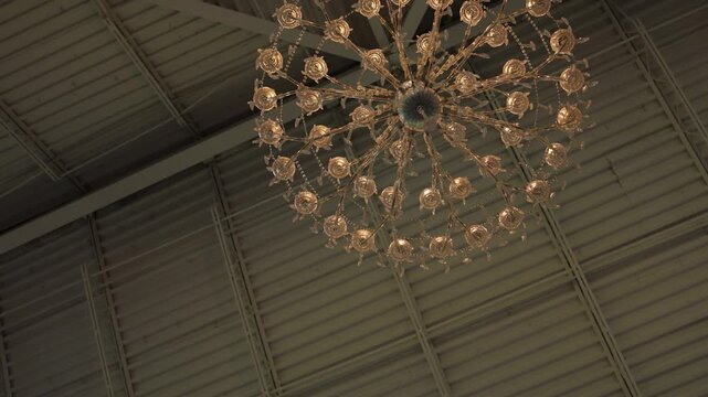 Decorative chandelier on an industrial ceiling