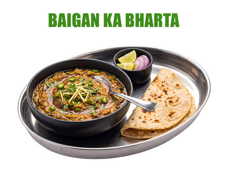 Indian food Baigan Ka Bharta featuring roasted eggplant mash curry with tandoori roti and lemon onions platter