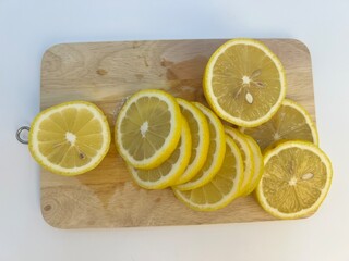 Fresh Sliced Lemons on Wooden Cutting Board Isolated on White Background lemon   © Nawn