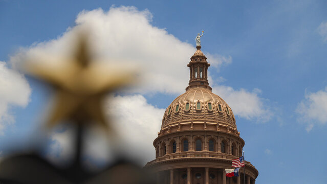 The Texas State Capitol building from a star on fence in Austin, Texas USA