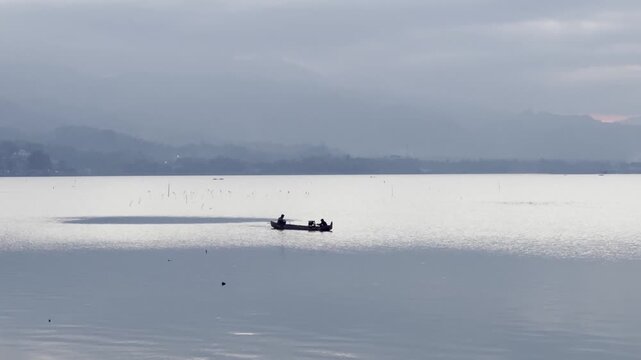 Fishermen on a Boat at Sunrise