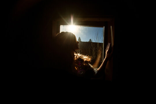 Silhouette of a woman in a window
