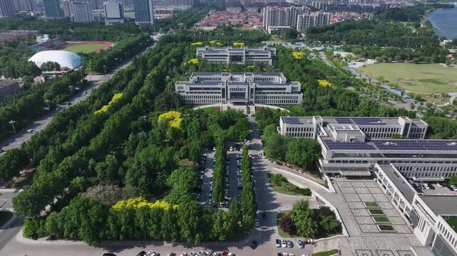 Aerial view of modern government office building complex in Rizhao with solar panels and greenery